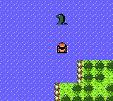A person in a small boat floats closer to where Nessie is hanging out in the water.