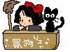 Kiki sits at a homemade desk a la Lucy from Peanuts